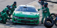 Aug 31, 2025; Darlington, South Carolina, USA; NASCAR Cup Series driver Todd Gilliland (34) pit crew at work on his car during the Cookouts Southern 500 at Darlington Raceway. Mandatory Credit: Jim Dedmon-Imagn Images